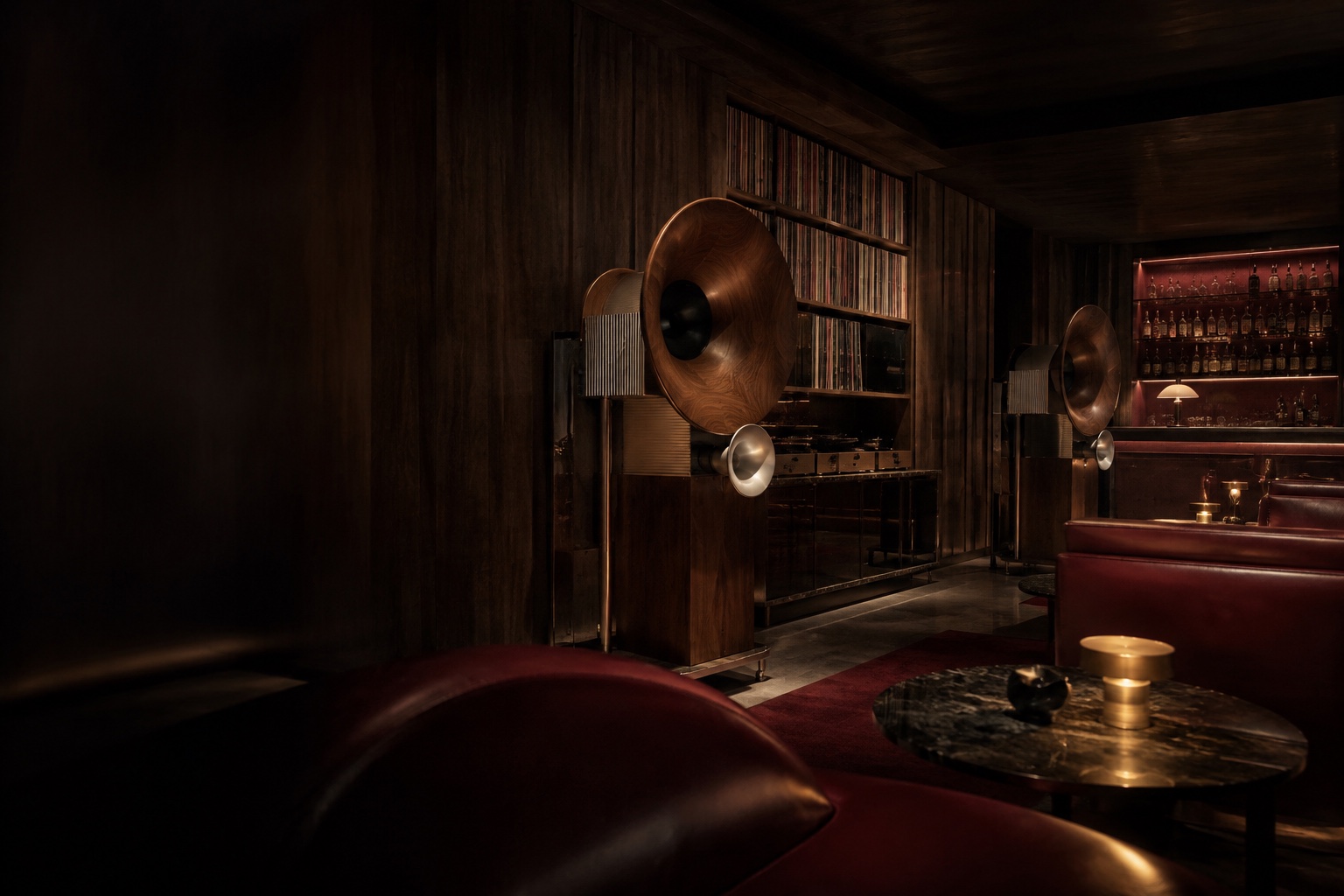 An intimate walnut listening lounge with sculptural horn speakers and warm amber light