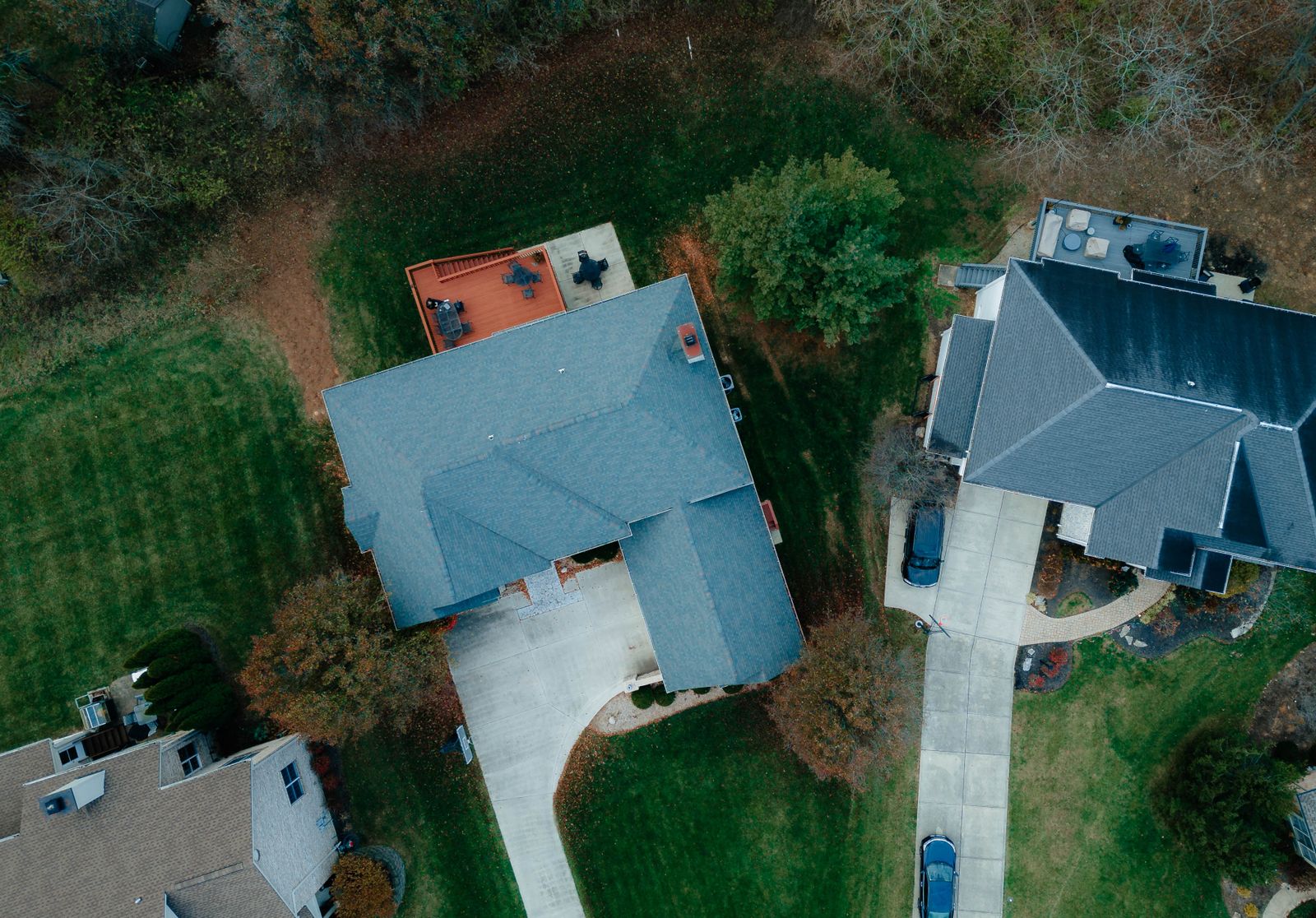 Aerial view of a suburban block with three roofs marked in chalk