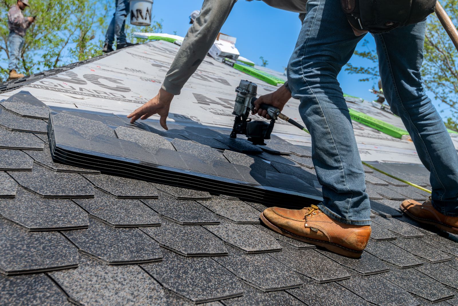 A field of new architectural shingles with a ten-by-ten hail test square chalked on it and eight hits circled